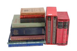 A collection of assorted books related to military interest.