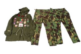 Two pairs of camouflage trousers and an over-jacket.