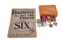 A small group of WWII medals and two WWI magazines.