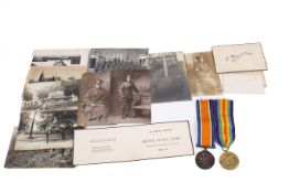 Two WWI medals and accompanying photographs.