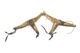 A pair of 20th century brass epaulettes. The overlapping plates mounted on brown leather.