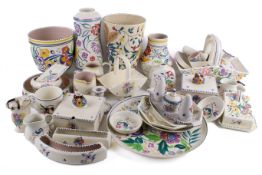A large collection of mid-century Poole Pottery items. Including vases, baskets and plates, etc.