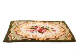 Hand knotted rug on a green ground (af).