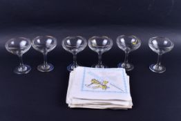 A set of six vintage Babycham coupe glasses with period paper napkins.