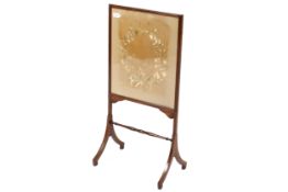 An Edwardian fire screen with embroidered floral wreath panel.