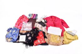 A collection of assorted vintage women's clothing, handbags and various textiles.