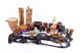 A collection of assorted carved animal and other figurines.