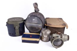 An assorted group of ex-military items. Including a spotlight and two lanterns, etc.