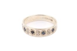 A 9ct white gold ring. Set with small sapphires and white chips, hallmarked, size N, gross weight 2.