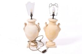 A pair of pottery table lamps in the form of urns. Raised on square bases.