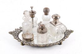 A small group of assorted silver and silverplate mounted bottles on a tray.