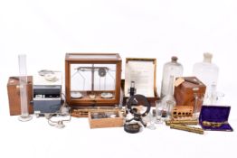 A large collection of scientific instruments. Including assorted glassware, a microscopes, etc.
