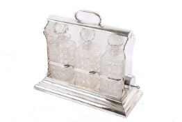 A Walker & Hall silverplated tantalus. Having three hobb nail cut decanters with stoppers.