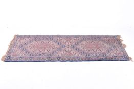 A modern Moroccan runner on a blue ground. Having geometric borders with Herati patterns.