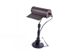 A contemporary bankers' style desk table lamp. Having a turned baluster column on a circular base.
