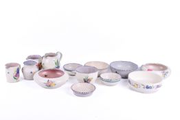 A collection of assorted mid-century Poole pottery items. Including milk jugs, etc.
