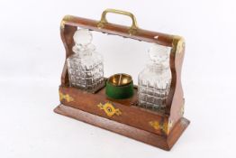 An oak cased tantalus. Having two decanters. A key present.