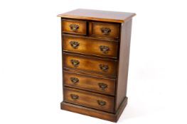 An oak chest of drawers. Having two short over four drawers.