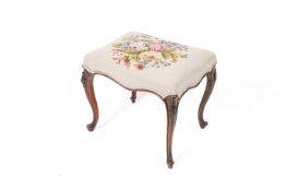 A 20th century French style stool with floral embroidered tapestry seat.