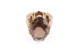 A yellow metal and smoky quartz ring. The stone measuring circa 2cm x 1.