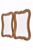 A pair of 20th century wavy gilt framed wall mirrors.