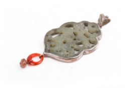 A silver mounted Chinese pierced seladon green jade pendant.
