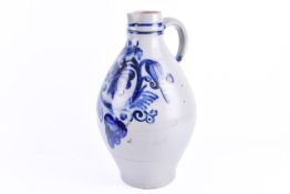 A continental stoneware jug, blue foliage decoration on a grey ground.