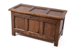 An 18th century three panel oak coffer. Raised on stile feet.