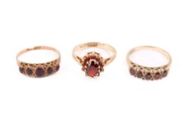 Three 9ct gold and garnet rings. All hallmarked, one of cluster form, gross weight 6.34g.