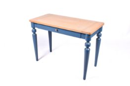 A contemporary oak top side table. Having a drawer with painted blue base.