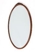 A mahogany framed oval wall mirror.