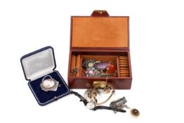 A small jewellery box with assorted costume jewellery and watches.