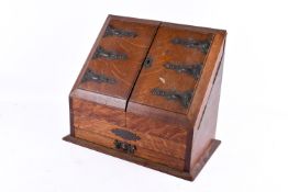 Late Victorian oak slope-front stationery cabinet.
