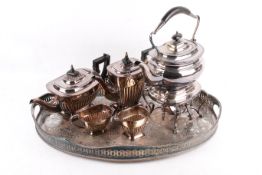 A four piece silver plated tea set with a spirit kettle on an oval tray.