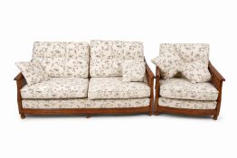 An Ercol bergere two piece suite. Consisting of a three seater sofa and an armchair.