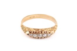 A yellow metal graduated five-stone diamond ring.