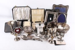 A collection of assorted silver plated items. Including photo frames and candlesticks, etc.