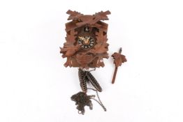 A 20th century 'Black Forrest' style stained pine cuckoo clock. Two weights and pendulum present.