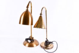 Two similar contemporary brass coloured table lamps with circular bases.