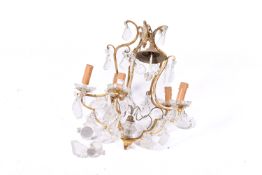 A gilt metal five branch chandelier.with glass drops.
