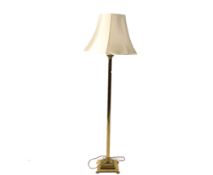 A contemporary brass standard lamp with corinthian column.