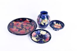 A group of four modern Moorcroft pottery items. Including 'pomegranate' plate (chip to rim), etc.