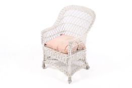 A vintage white wicker chair with upholstered seat cushion.