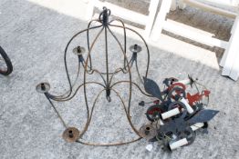 A wrought metal six-arm candelabra with four wall lights,