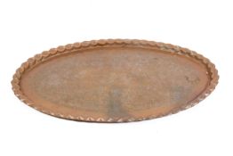A large Persian style oval brass tray with engraved foliage decoration.
