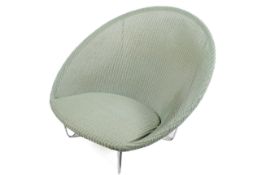 A large, green beige Vincent Sheppard 'Jo Cocoon' chair with Lloyd Loom style weave.