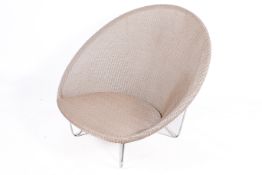 A large, dark beige Vincent Sheppard 'Jo Cocoon' chair with Lloyd Loom style weave.