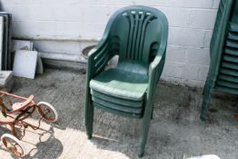 A set of four Flair Plaisir green plastic stacking garden patio chairs.