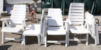 Set of four Hartman Carlton white plastic folding garden patio chairs, one other, and a small table.
