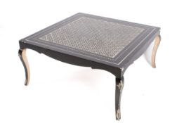 A contemporary black painted coffee table with repeating geometric,